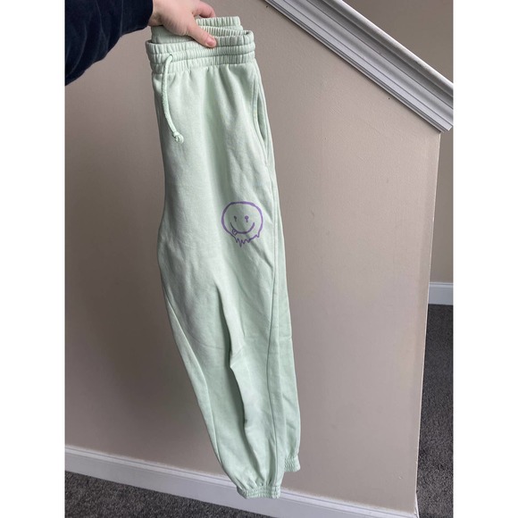Divided Mint green joggers with purple smiley face, size XS - Picture 1 of 7